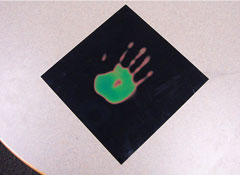 Liquid crystal thermal sheet with a handprint on it