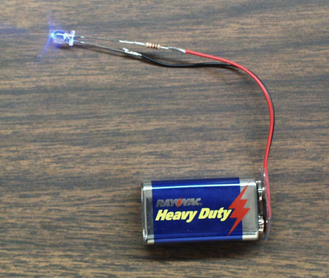 LED circuit connected to battery and emitting blue light
